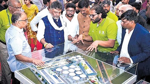 Deputy Chief Minister DK Shivakumar inspects a scale model of the integrated solid waste segregation unit at Kannahalli on Magadi Main Road on Monday