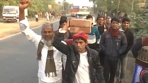 A supporter of suspended TMC MLA Humayun Kabir walks to Murshidabad carrying bricks on his head to contribute to the proposed Babri Masjid-style mosque