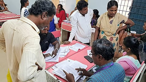 People filling up enumeration forms at SIR