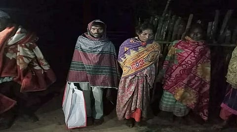 tribal family carries infant's body in plastic bag