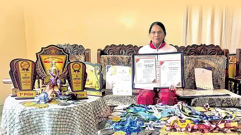 Manjamma B with her certificates, medals and trophies