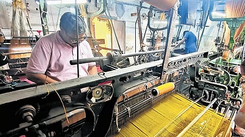 KC Dwarakish weaves 20 metres of cloth a day on one of his looms.