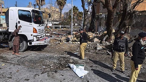 Police officers examine the site of Saturday's suicide bombing, in Quetta, Pakistan, Sunday, Feb. 1, 2026.