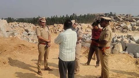 SP Shivanshu Rajput speaks to workers at a quarry at Banagere village in KGF on Friday while DySP Lakshmaiah looks on.