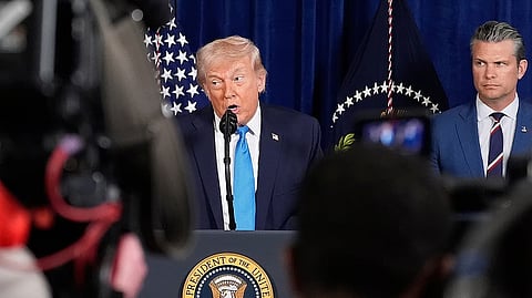 US President Donald Trump speaks as Defense Secretary Pete Hegseth listens.