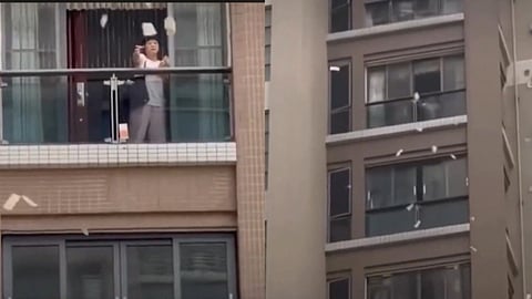 Chinese woman tosses out ₹1.5 crore cash from balcony after argument with husband