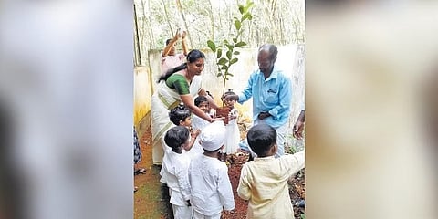 ಮಕ್ಕಳಿಂದ ಸಸಿ ನೆಡಿಸುತ್ತಿರುವ ಕಣ್ಣನ್.