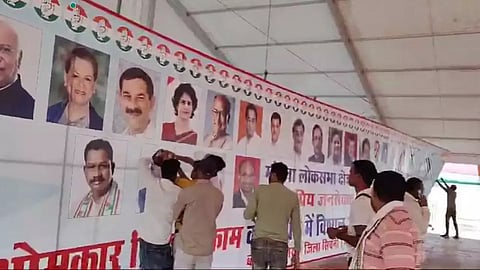 congress party workers covering union minister's photo