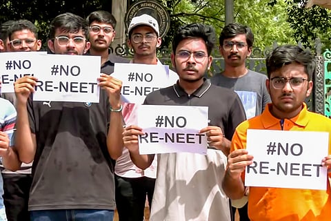 Students hold placards as they stage a protest against the re-examination of the NEET-UG exams, in Rajkot on Sunday.ANI
