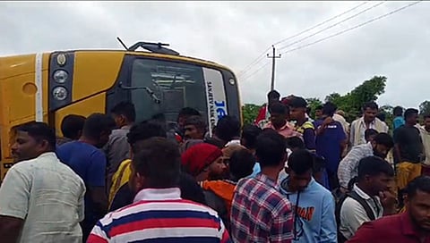 ಪಲ್ಟಿಯಾದ ಶಾಲಾ ಬಸ್ ಬಳಿ ಸೇರಿರುವ ಜನರು