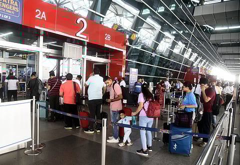 Flight passengers align at security check points in the Indira Gandhi International Airport of New Delhi on July 19, 2024 as airlines reported disruptions amid global IT outage.