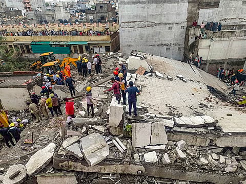 Officials and others during a rescue operation after a building collapse, in Surat district, Saturday, July 6, 2024