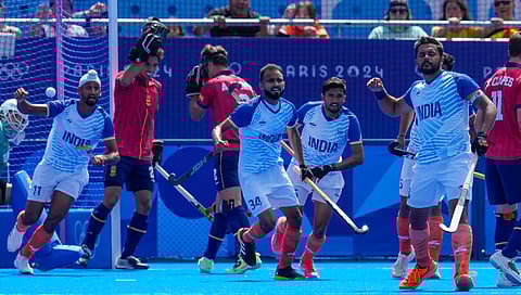 India's Harmanpreet Singh, right, celebrates after scoring his side's first goal during the men's bronze medal field hockey match between Spain and India during the 2024 Summer Olympics.
