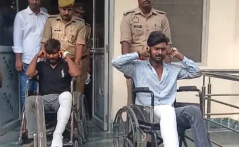 The two arrested accused are seen holding their ears and pleading for forgiveness