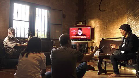 People attend a televised speech by the leader of the Hezbollah movement Hassan Nasrallah inside a house in the southern Lebanese village of Zawatar on September 19, 2024