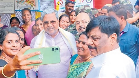 A woman takes a selfie with Chief Minister Siddaramaiah after the launch of several welfare works in Varuna constituency, in Mysuru on Tuesday