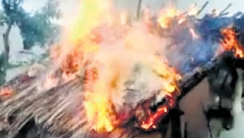 A file photo of huts set on fire at Marukumbi village in Koppal in 2014