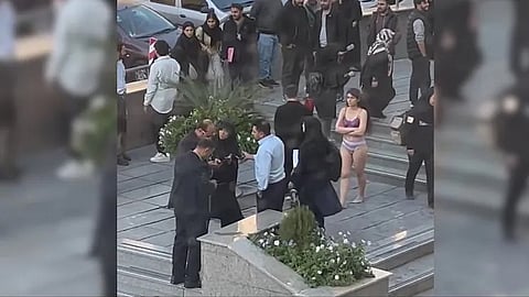 Iranian university student strips in protest