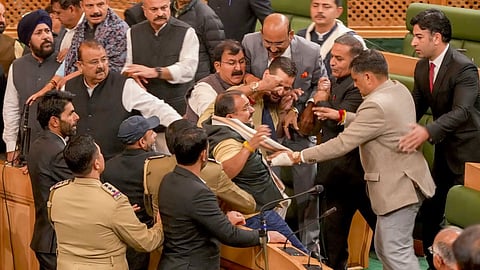 Ruckus in the Jammu and Kashmir Assembly after the speaker directed eviction of opposition members who had stormed the well during their protest over the special status resolution, in Srinagar, Thursday.