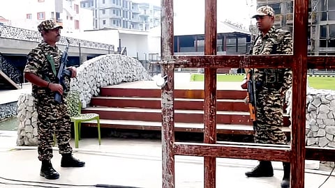Security personnel stand guard during a raid by the Enforcement Directorate in connection with a money laundering investigation linked to alleged illegal infiltration of Bangladeshi nationals, in Ranchi.