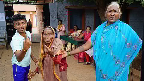 Nonagenarian Hulegamma shows her inked finger after voting in Sandur