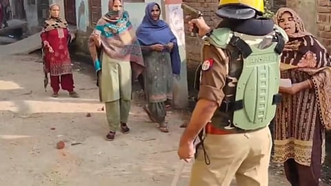 In a video shared by SP chief Akhilesh Yadav, a police officer is seen pointing his revolver at Muslim women coming out to vote. 