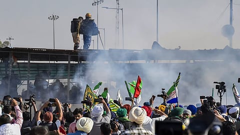 Tear gas being used by security personnel to disperse the farmers moving towards barricades during their foot march to Delhi, at Shambhu border in Patiala district.