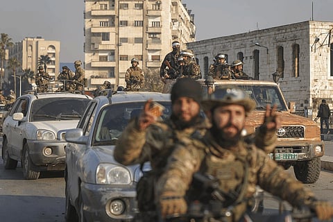 Syrian opposition fighters take to the streets in the aftermath of the opposition's takeover of Hama, Syria, Friday, Dec. 6, 2024.