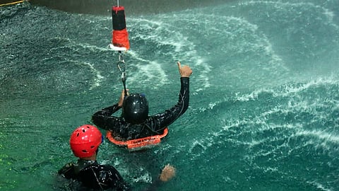 Navy personnel demonstrate rescue of pilots in turbulent water at the Water Survival Training Facility in Kochi