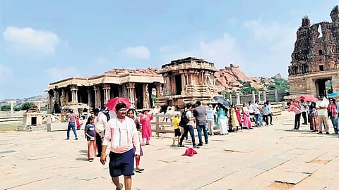 Tourists on the premises of Vijaya Vittala Temple in Hampi,