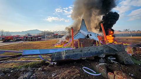Fire and smoke rise from the tail section of a Jeju Air Boeing 737-800 series aircraft after the plane crashed and burst into flames at Muan International Airport in South Jeolla Province, some 288 kilometres southwest of Seoul on December 29, 2024