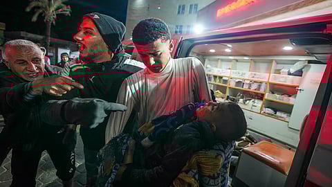 The body of 8-year-old Adam Farajallah is brought to Al-Aqsa Martyrs Hospital following an airstrike on a house in the Bureij refugee camp, in the central Gaza Strip town of Deir al-Balah, Wednesday, Jan. 1, 2025.