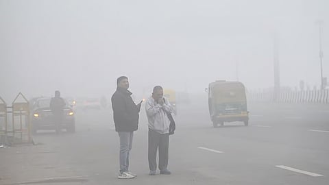 Commuters amid low visibility due to a very dense fog on a cold winter morning in New Delhi, Friday, Jan. 10, 2025.