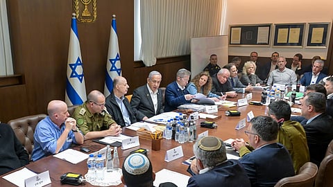 This photo provided by the Israeli Government Press Office, Israeli Prime Minister Benjamin Netanyahu, center, convened his security Cabinet to vote on a ceasefire deal.