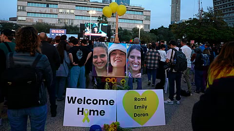 Supporters and relatives of hostages held captive in the Gaza Strip since the October 7, 2023 attacks by Palestinian militants, react while watching a live television broadcast on the release of Israeli hostages, at the Hostages Square in Tel Aviv, on January 19, 2025.
