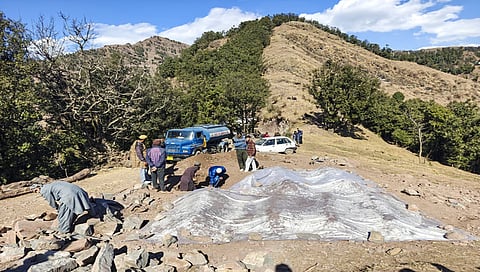 People dig a grave for the burial of Yasmeen Kouser, the 17th victim of the 'mysterious' illness