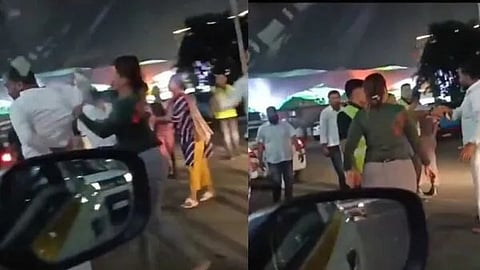 a woman physically assaulting a car driver 