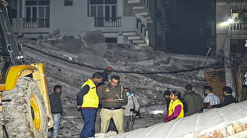 Police at the site of the building collapse in Burari area of New Delhi.
