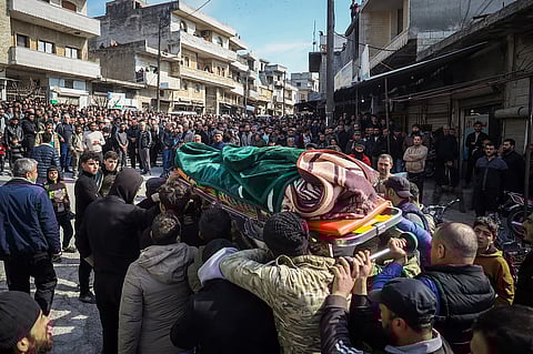 Relatives and neighbours attend funeral procession for four Syrian security force members killed in clashes with loyalists of ousted President Bashar Assad in coastal Syria, in the village of Al-Janoudiya, west of Idlib, Saturday, March 8, 2025. 
