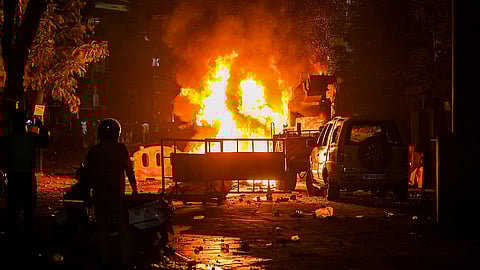 A fire set by miscreants amid violence following an agitation by a right-wing group demanding removal of Aurangzeb's tomb, in Nagpur on Monday night, March 17, 2025.