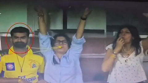 Lady blows whistle from the neck of another fan 