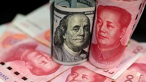 This photo shows Chinese 100 yuan notes and US 100 dollar bills, in Beijing, on April 8, 2025.