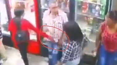Woman grabs the mans private part infront of his wife