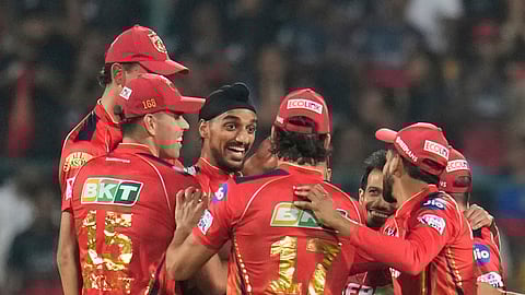 Punjab Kings' Arshdeep Singh celebrates with teammates the wicket of Royal Challengers Bengaluru's Phil Salt