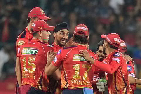 Punjab Kings' Arshdeep Singh celebrates with teammates the wicket of Royal Challengers Bengaluru's Phil Salt