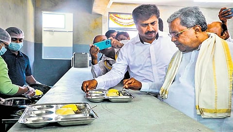 Siddaramaiah samples chow chow bath during the inauguration of a new Indira Canteen outlet