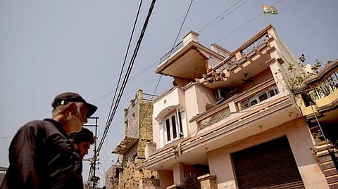 A triclour is seen on top of a damaged house, following Pakistani shelling in Rehari, Jammu, May 10, 2025. 
