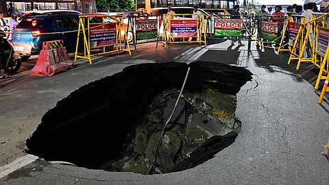 A road caved in through which a car fell at the Tidel Park signal on Saturday.