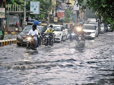 Traffic crawls on waterlogged roads as heavy rain lashes Bengaluru. 