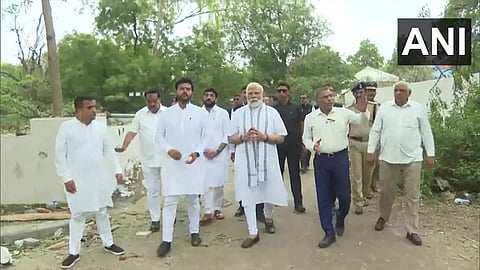 Prime Minister Modi receiving information from officials.